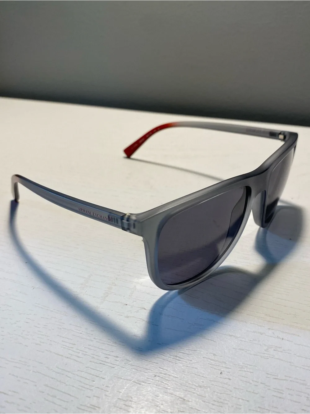Armani Exchange Men’s Translucent Gray Sunglasses with Red Temple Tip